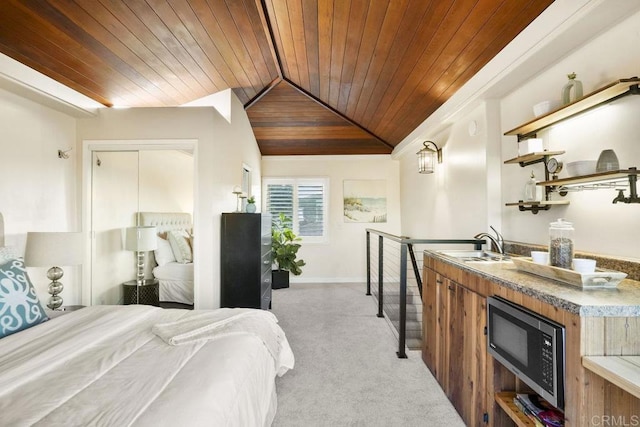 bedroom with vaulted ceiling, sink, light carpet, and wooden ceiling