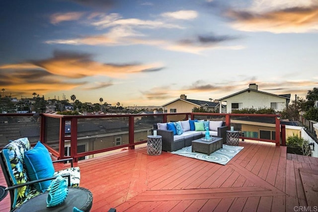 deck at dusk with an outdoor hangout area