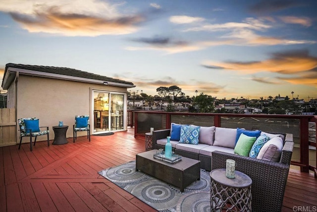 deck at dusk featuring outdoor lounge area