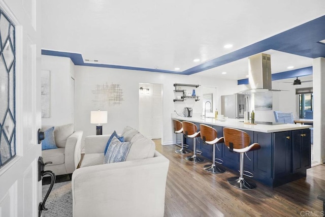 living room with sink and hardwood / wood-style flooring