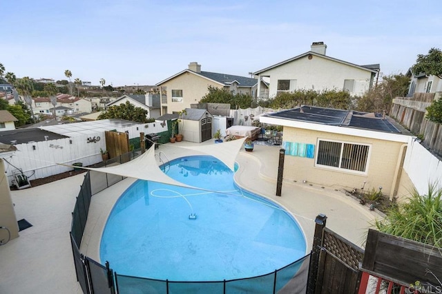 view of swimming pool featuring a shed