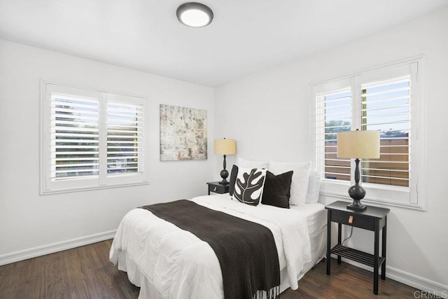 bedroom with dark hardwood / wood-style floors