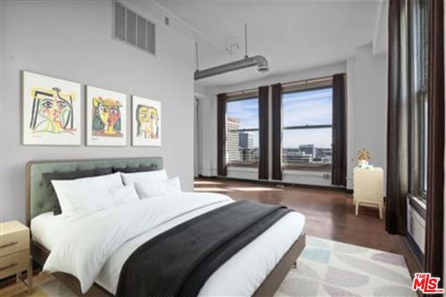 bedroom with hardwood / wood-style floors