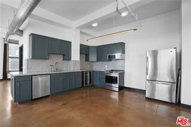 kitchen with blue cabinets, backsplash, wine cooler, and appliances with stainless steel finishes