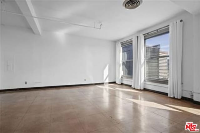 empty room with beam ceiling