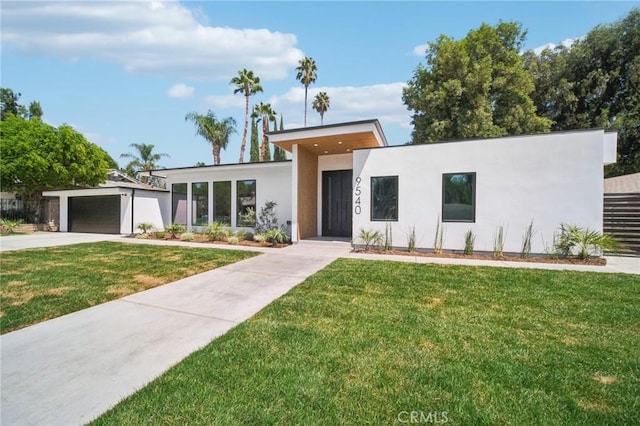 contemporary house featuring a garage and a front lawn