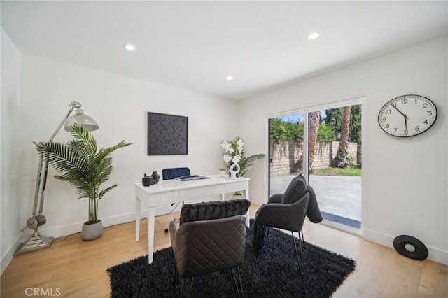 home office with light hardwood / wood-style floors