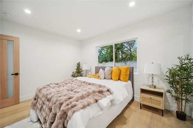 bedroom with light hardwood / wood-style floors