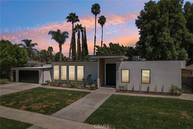 modern home with a garage and a yard