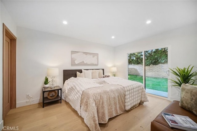 bedroom featuring access to exterior and light hardwood / wood-style flooring