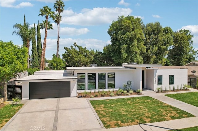 modern home with a garage and a front lawn