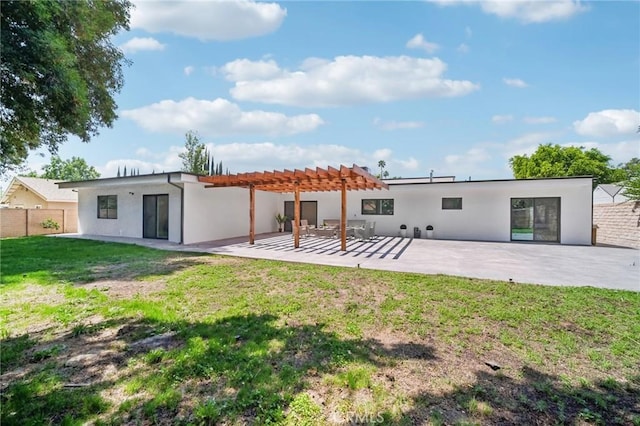 rear view of house with a yard, a pergola, and a patio area