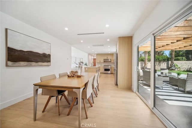 dining space with light wood-type flooring