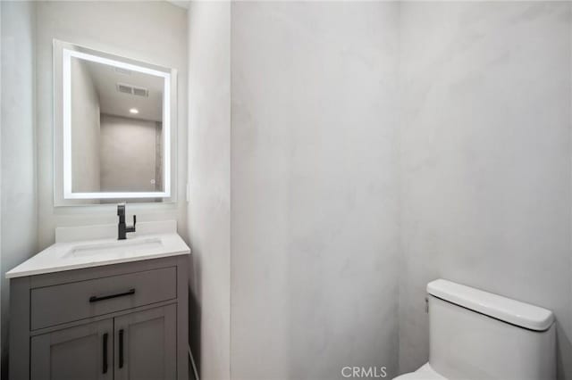 bathroom featuring vanity and toilet