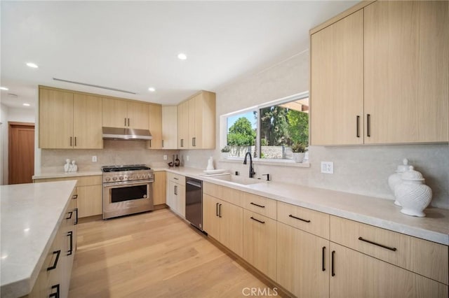 kitchen featuring light brown cabinetry, high end stainless steel range, sink, dishwasher, and backsplash