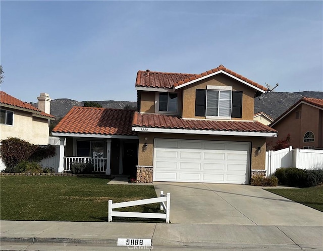 view of front of home with a garage, a porch, and a front yard