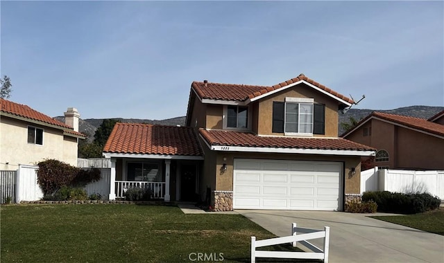 view of front facade featuring a garage, a front lawn, and a porch