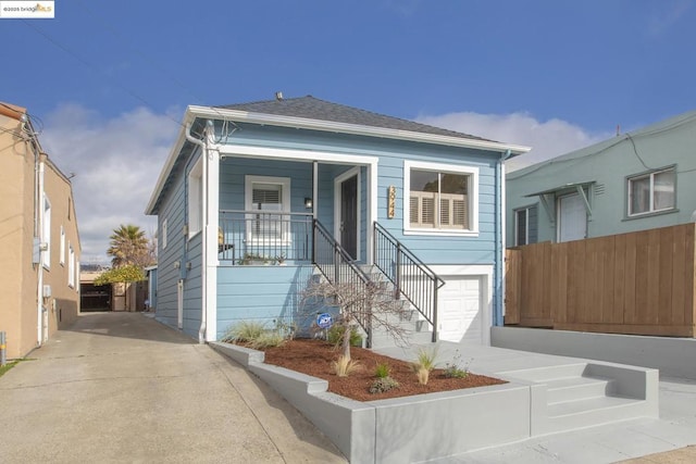 bungalow with a garage and covered porch