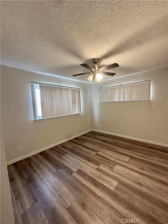 spare room with hardwood / wood-style floors, a textured ceiling, and ceiling fan