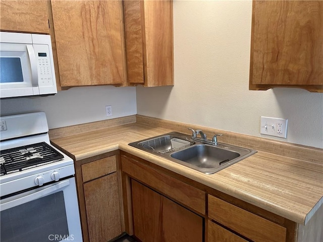 kitchen with sink and white appliances