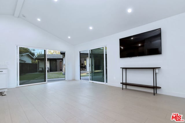 unfurnished living room featuring light hardwood / wood-style flooring, high vaulted ceiling, and beamed ceiling