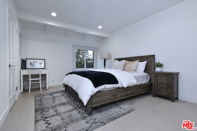 bedroom featuring light hardwood / wood-style flooring and beamed ceiling