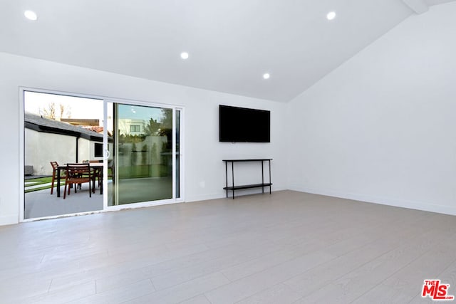 unfurnished living room with lofted ceiling and light hardwood / wood-style flooring