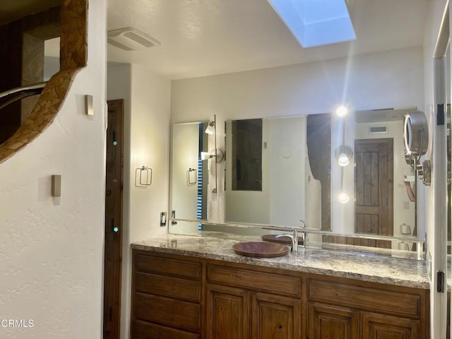 bathroom with vanity and a skylight