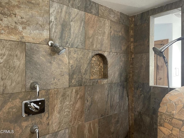 interior details featuring tiled shower