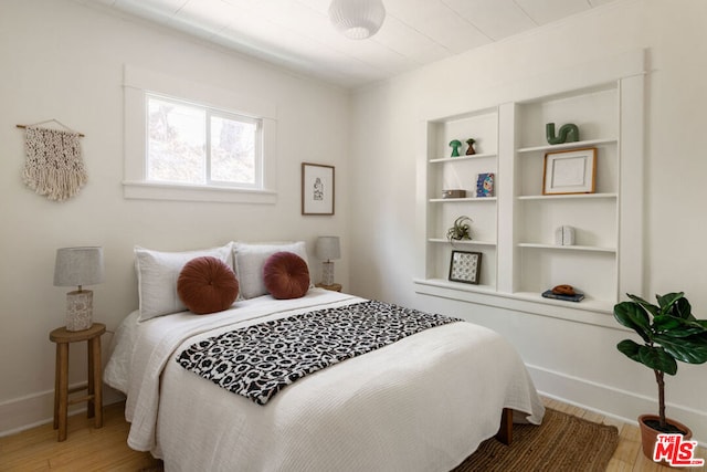 bedroom with wood-type flooring