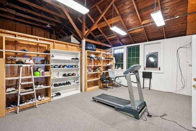 exercise area featuring vaulted ceiling and carpet floors