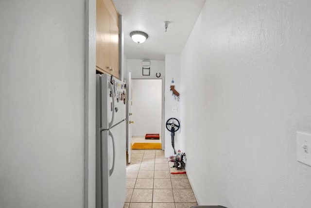 kitchen featuring white fridge and light tile patterned floors