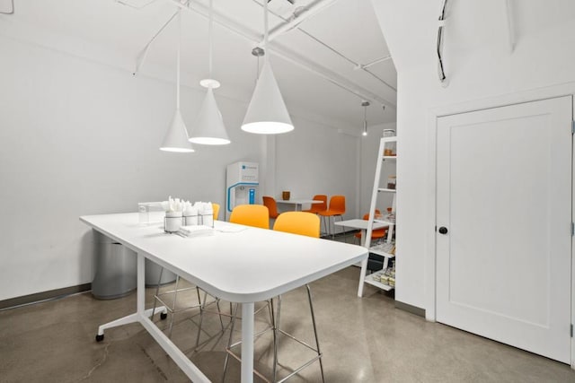 dining space with concrete flooring