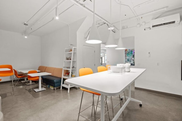 interior space with a wall mounted air conditioner and concrete floors