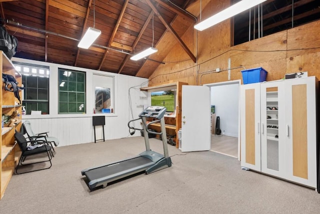 workout area featuring high vaulted ceiling, carpet floors, wood ceiling, and wood walls