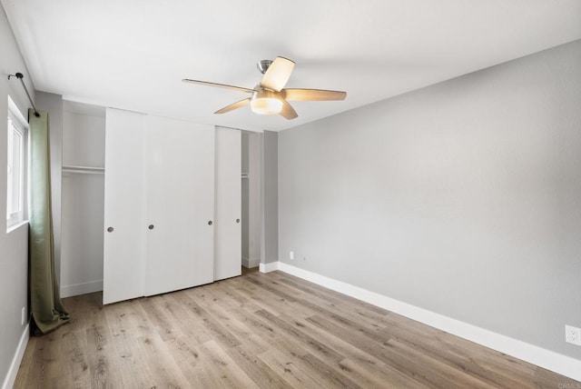 unfurnished bedroom featuring a closet, ceiling fan, and light wood-type flooring