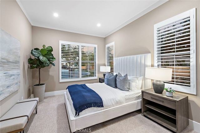 bedroom with crown molding and light colored carpet