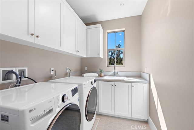 clothes washing area featuring sink, light tile patterned floors, cabinets, and independent washer and dryer