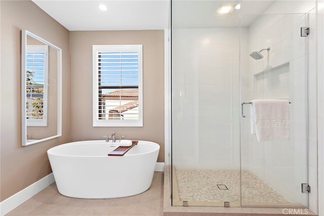 bathroom featuring tile patterned floors and shower with separate bathtub