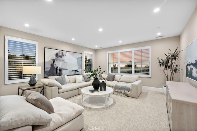 living room featuring light carpet and a wealth of natural light