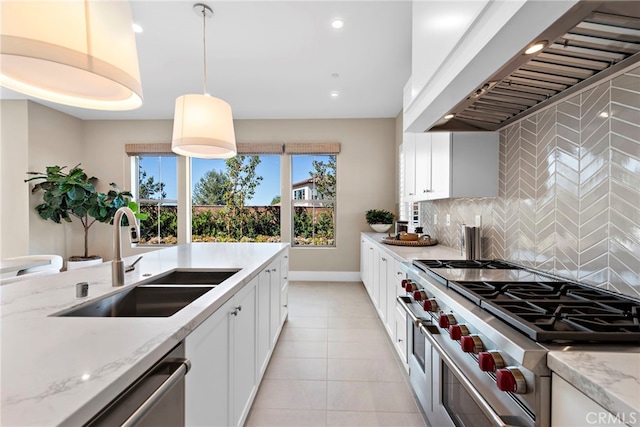 kitchen with decorative light fixtures, sink, white cabinets, stainless steel appliances, and custom range hood