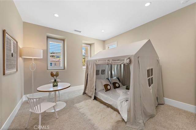 bedroom featuring light colored carpet