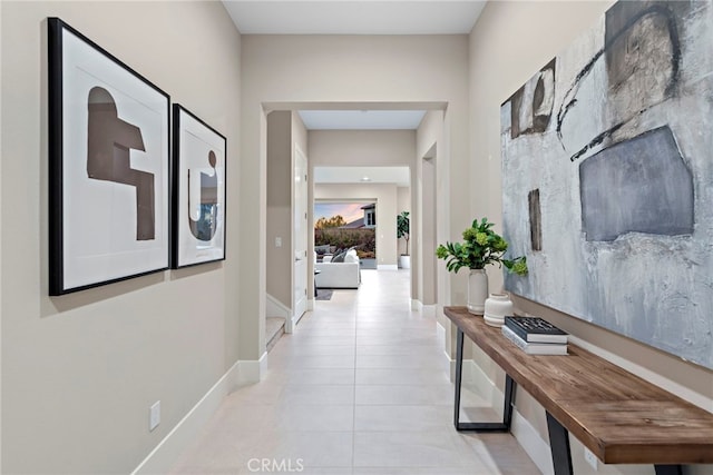 hall with light tile patterned floors