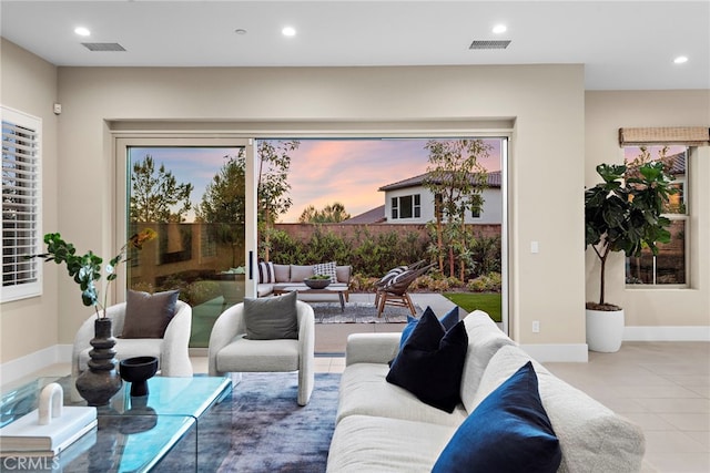 living room with a wealth of natural light and light tile patterned floors