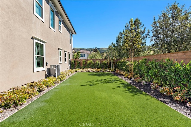 view of yard featuring central air condition unit