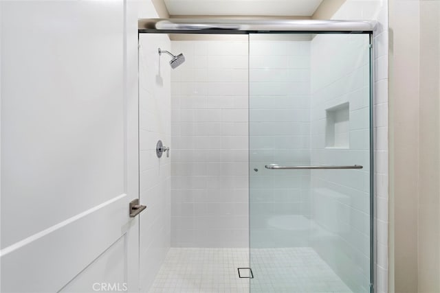 bathroom with a shower with shower door