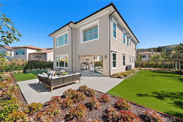 rear view of house with an outdoor living space, a yard, and a patio