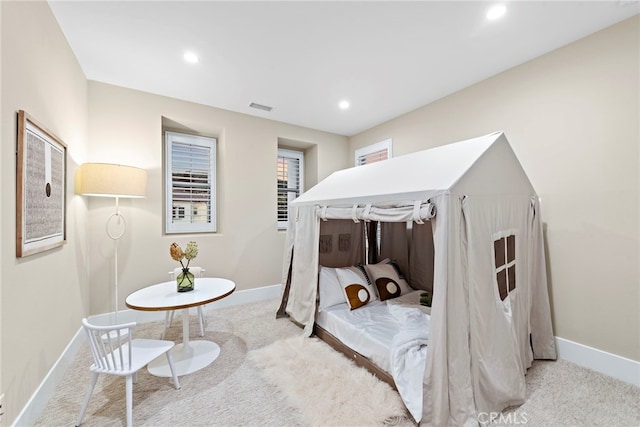 bedroom with light colored carpet