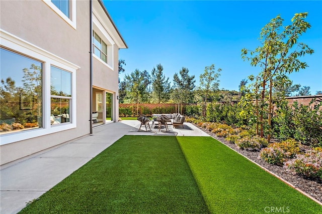 view of yard with an outdoor living space and a patio area