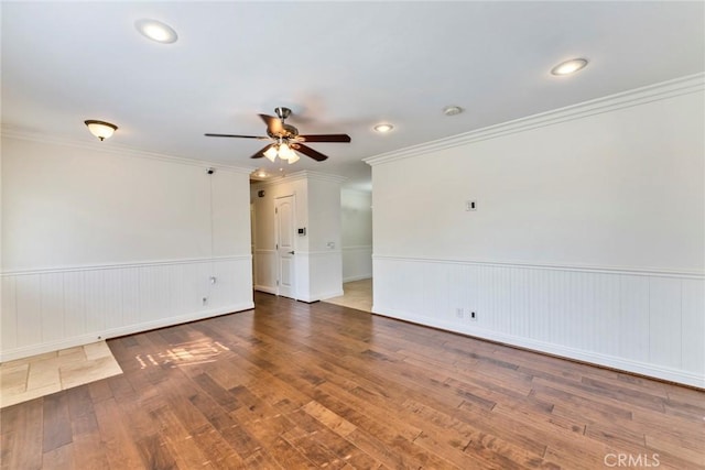 unfurnished room featuring ceiling fan, ornamental molding, and dark hardwood / wood-style floors